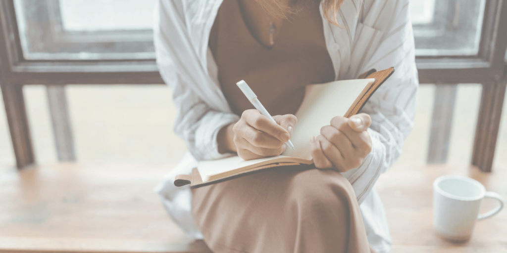 woman writing in notebook